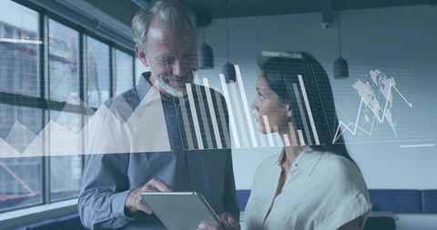 Business Colleagues Analyzing Data on Tablet at Office