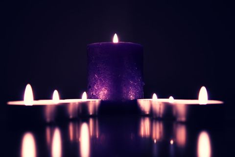 Purple Candle with Tealights in Dark Ambience Creating Arty Shadows