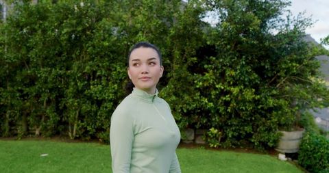 Woman Enjoying Nature in Her Backyard in Activewear