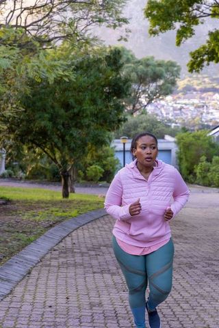 Confident Woman Jogging Outdoors on Brisk Morning