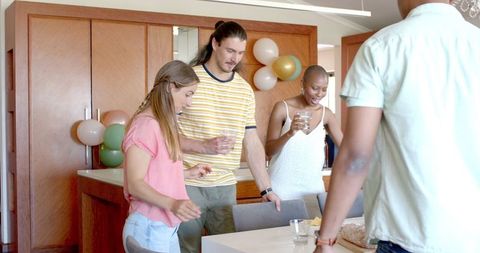 Friends Enjoying Meal Together in Modern Home Setting