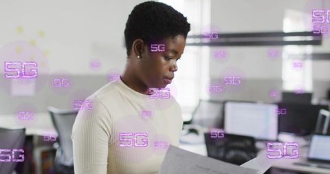 Businesswoman Analyzing Documents with 5G Technology Overlay