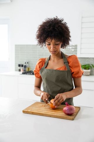 Home Chef Slicing Onion in Bright Modern Kitchen