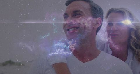 Smiling couple hugging with nebula overlay creating romantic cosmic portrait