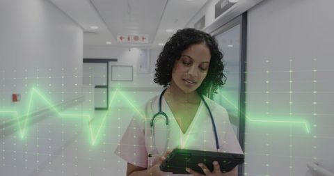 Biracial Doctor Analyzing Medical Data on Tablet with ECG Overlay - Download Free Stock Images Pikwizard.com