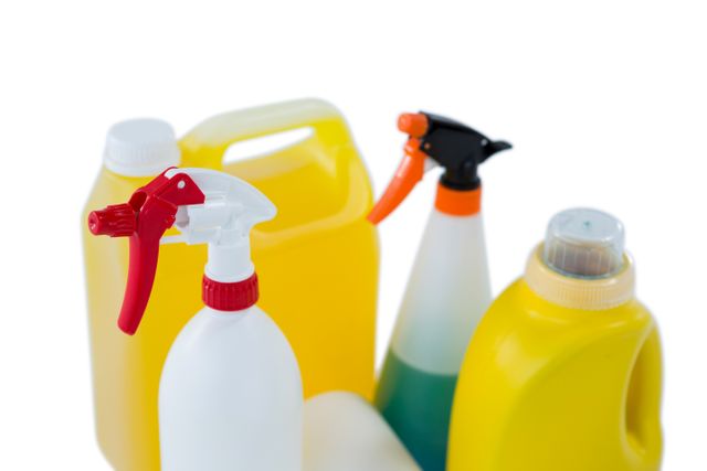 High angle view of spry bottles against white background