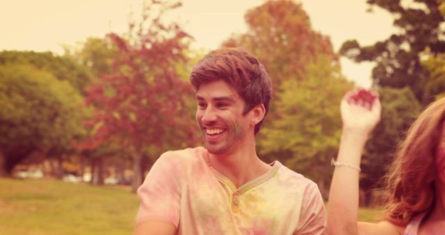 Young Man Celebrating Holi Festival with Friends Covered in Colorful Powder - Download Free Stock Images Pikwizard.com