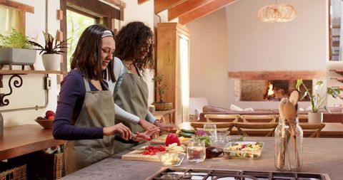 Diverse Female Friends Cooking Together in Rustic Kitchen