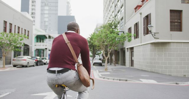 Man Cycling Through Urban Street With Messenger Bag - Download Free Stock Images Pikwizard.com