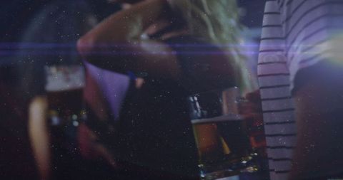 People Socializing at a Bar with Atmospheric Lighting