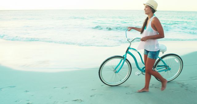 Happy beautiful woman walking on the beach with a bicycle 4k