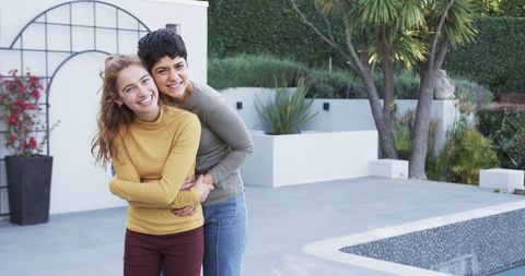 Happy Lesbian Couple Embracing in Garden