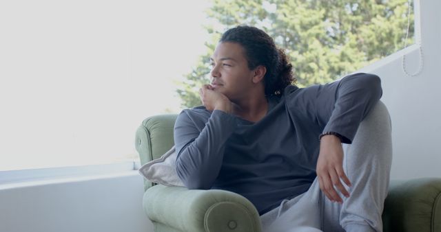 Young Man Reflecting by Window in Casual Loungewear - Download Free Stock Images Pikwizard.com