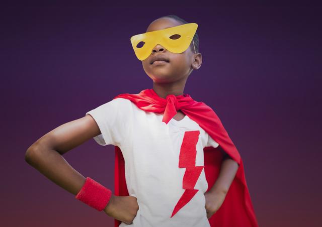 This image of a girl in a superhero costume with her hands on her hips is perfect for promoting children's events, educational materials, or products related to empowerment and creativity. It can also be used in advertisements for costumes, toys, or children's clothing. The vibrant colors and confident pose make it ideal for inspiring confidence and imagination in young audiences.