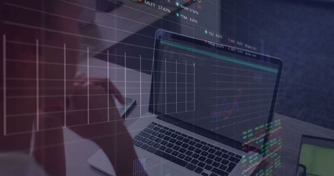 Analyzing Financial Data on Laptop at Modern Workspace