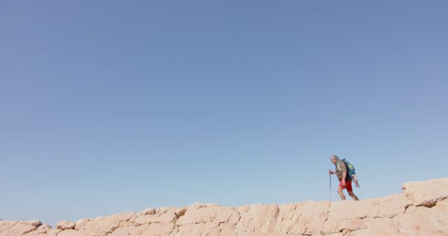 Hiker Walking Along Rocky Ridge Under Clear Blue Sky - Download Free Stock Images Pikwizard.com