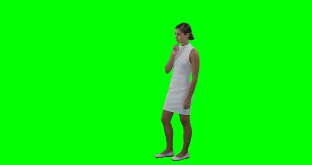 Young woman wearing white dress thinking with hand on chin against green screen background. Perfect for use in multimedia projects, advertisements, or visual content requiring a customizable background. Useful for compositing, model placement into various settings, promoting fashion, or conceptual themes related to decision-making and contemplation.