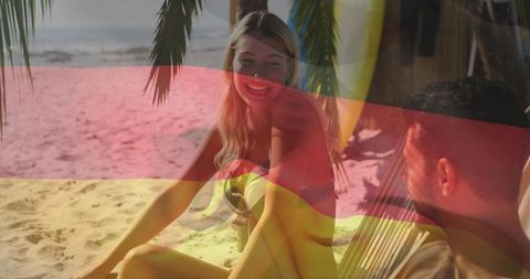 Couple relaxing on tropical beach with german flag overlay for summer travel campaign