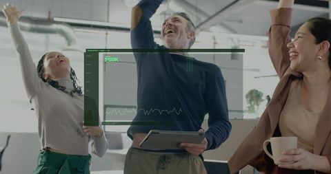 Team celebrating $120k revenue milestone, raising arms and smiling in modern office