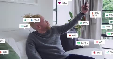 Man raising phone while social media notifications multiplying in modern home