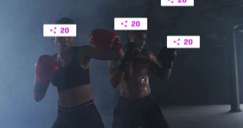 Intense sparring session with athletic man and woman in dark gym