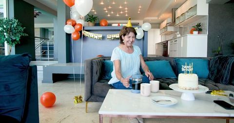 Senior Woman Celebrating Birthday with Coffee at Home