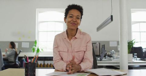 Confident Businesswoman Smiling at Desk in Bright Modern Office - Download Free Stock Images Pikwizard.com