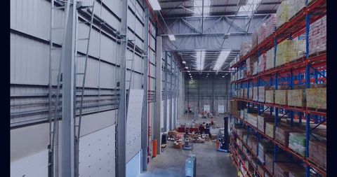 Industrial warehouse storage with metal racking and stacked pallets