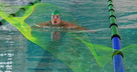Professional swimmer performing breaststroke in olympic pool