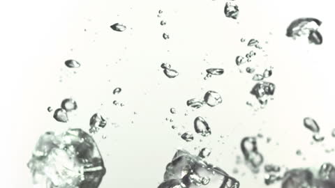 Ice Cubes Splashing into Water in Slow Motion