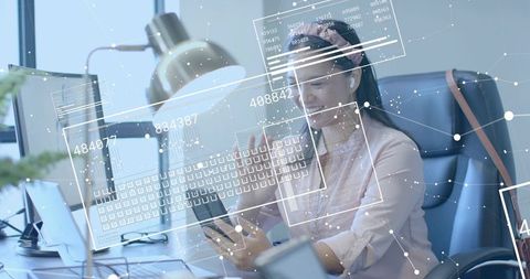 Innovative Woman Analyzing Digital Data on Smartphone in Office