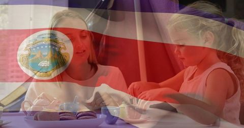 Mother and Daughter Preparing Treats with Costa Rican Flag Overlay
