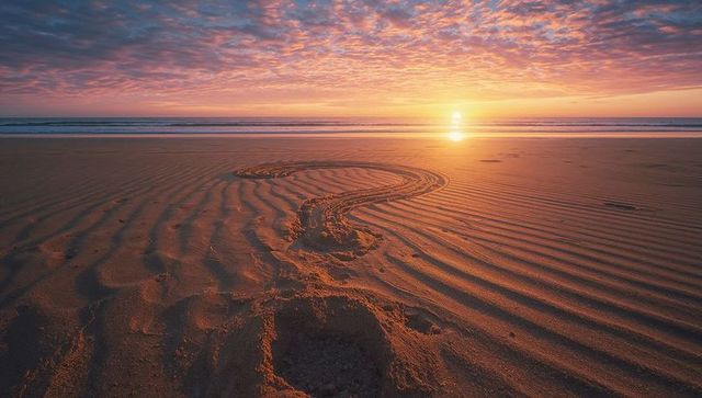 Question Mark Dragged in Sand as Sun Sets over Tranquil Ocean