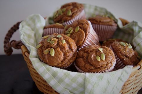 Freshly Baked Pumpkin Muffins in Woven Basket with Pumpkin Seeds