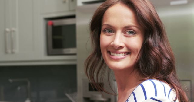 Smiling Woman in Kitchen with Striped Shirt - Download Free Stock Images Pikwizard.com