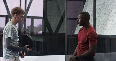 Diverse Male Friends Conversing on Pickleball Court