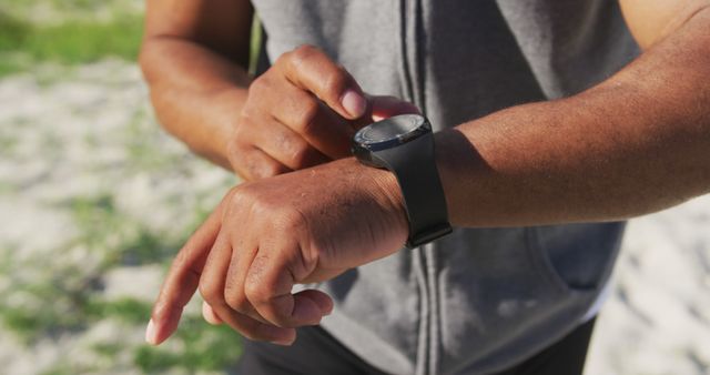 Man Checking Smartwatch During Outdoor Exercise - Download Free Stock Images Pikwizard.com