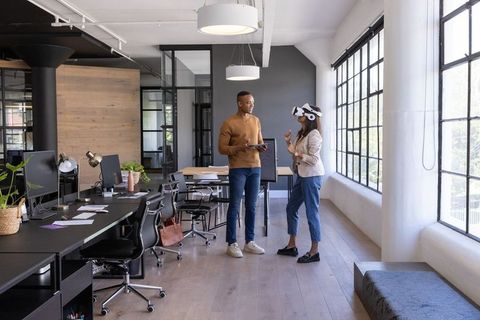 Coworkers Engaging with Virtual Reality in Modern Workplace