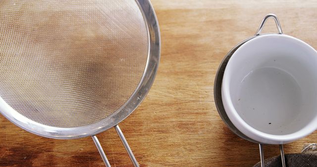 Stainless Steel Strainer and Empty White Bowls on Wooden Table - Download Free Stock Images Pikwizard.com