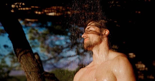 Young Man Enjoying Refreshing Outdoor Shower in Nature - Download Free Stock Images Pikwizard.com