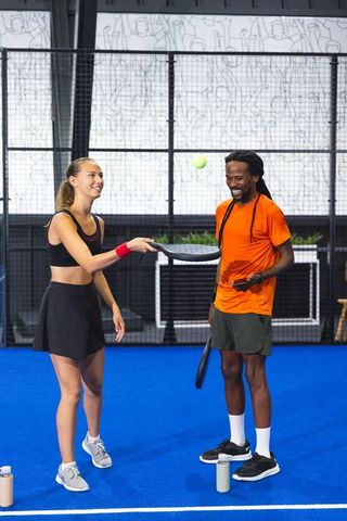 Diverse athletes enjoying padel game in modern indoor court