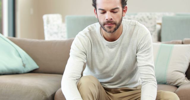 Young Man Relaxing at Home Sitting on Sofa - Download Free Stock Images Pikwizard.com