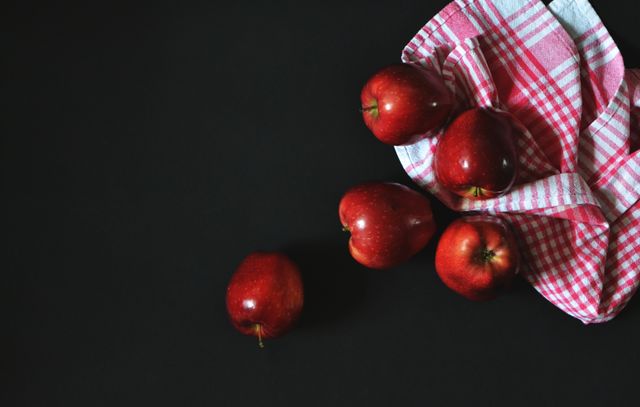 Fresh Red Apples on Black Background with Checkered Cloth - Download Free Stock Photos Pikwizard.com