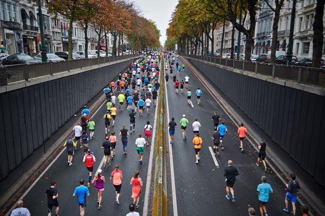 Overhead view of people running in a marathon on the street. Sports and fitness concept