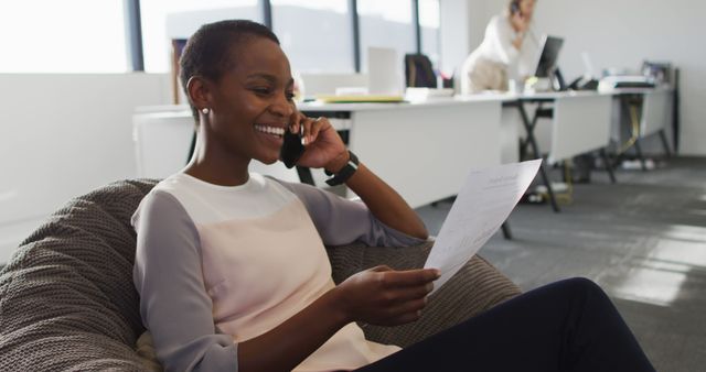 Happy Businesswoman Talking on Phone While Working in Modern Office - Download Free Stock Images Pikwizard.com