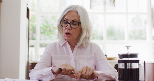 Senior Woman with Gray Hair Reading in Bright Room - Download Free Stock Images Pikwizard.com