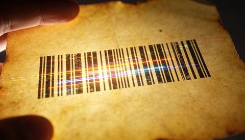 Aged parchment showing worn barcode with laser light streaks and vintage texture