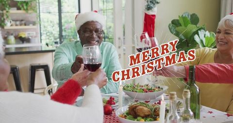 Senior Friends Toasting Christmas Cheer at Holiday Dinner Table