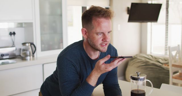 Man Sending Voice Message in Kitchen with French Press Coffee - Download Free Stock Images Pikwizard.com