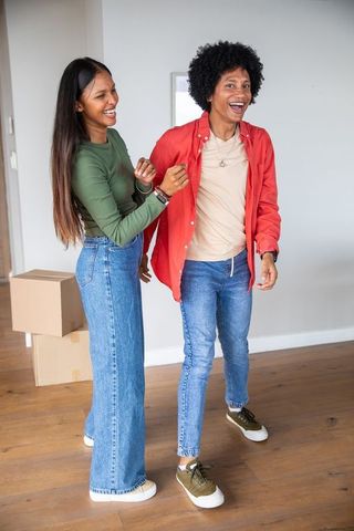 Diverse Couple Laughing Together During Move